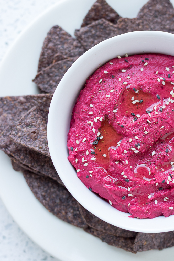 This easy Roasted Beet Hummus recipe has seasonal, freshly roasted beets, warm cumin, tahini, and chickpeas. Enjoy this appetizer with your favorite chips or pita bread and don't forget to share!