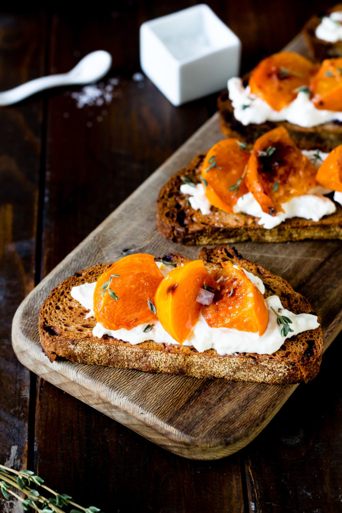 This Roasted Persimmon Burrata Crostini recipe will be the star of the show at your next get together. Roasted persimmon, creamy Burrata cheese, and fresh thyme top crunchy bread for an appetizer that's irresistible!