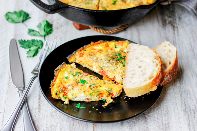 Parmesan Feta Tomatoes Frittata is a 30-minute brunch meal perfect any time of day. This one-pan meal is an egg-based comfort food that will impress guests!