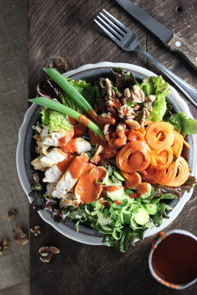 Wake up your tastebuds with this Cranberry Vinaigrette Winter Salad recipe. A crisp mix of winter veggies, chicken, and walnuts is covered in a delightful vinaigrette with a spicy kick thanks to the secret ingredient!