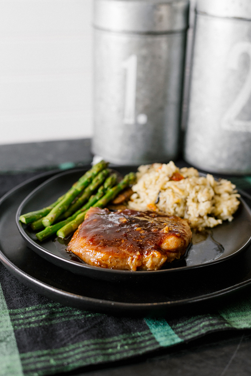 Easy, effortless, budget friendly, and ready in about 30 minutes, these Honey Garlic Glazed Pork Chops use kitchen staples for the sauce. Served with a side of asparagus, mushrooms, and rice, this meal is sure to impress!