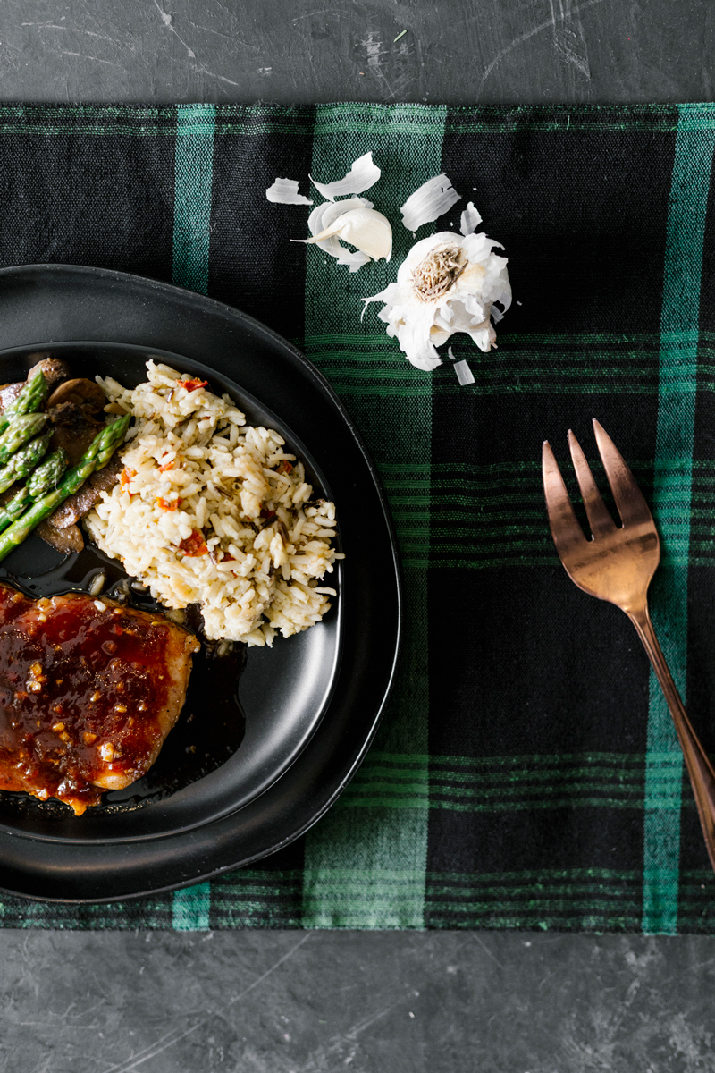 Easy, effortless, budget friendly, and ready in about 30 minutes, these Honey Garlic Glazed Pork Chops use kitchen staples for the sauce. Served with a side of asparagus, mushrooms, and rice, this meal is sure to impress!