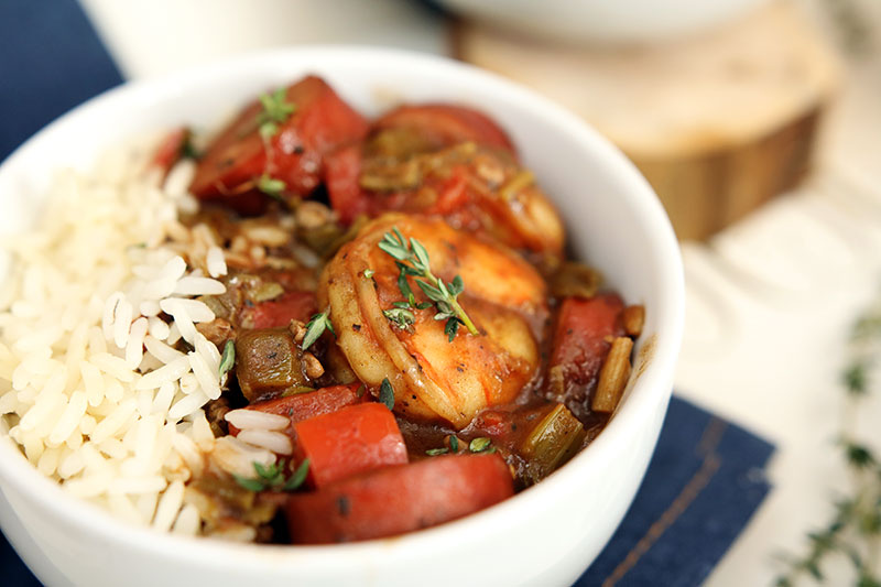 Cook to impress when you make this Insanely Delicious Shrimp Sausage Gumbo and rice bowl. This hearty comfort food gets its New Orlean's style flavor from smoky sausage, shrimp, herbs, and fresh vegetables.