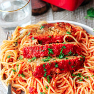 This Italian-Style Meatloaf recipe is a simple weeknight meal that is essentially a giant meatball, but easier to make. This delicious twist on a family favorite has all of the Italian flavors you love mixed in with beef, pork, and veal!