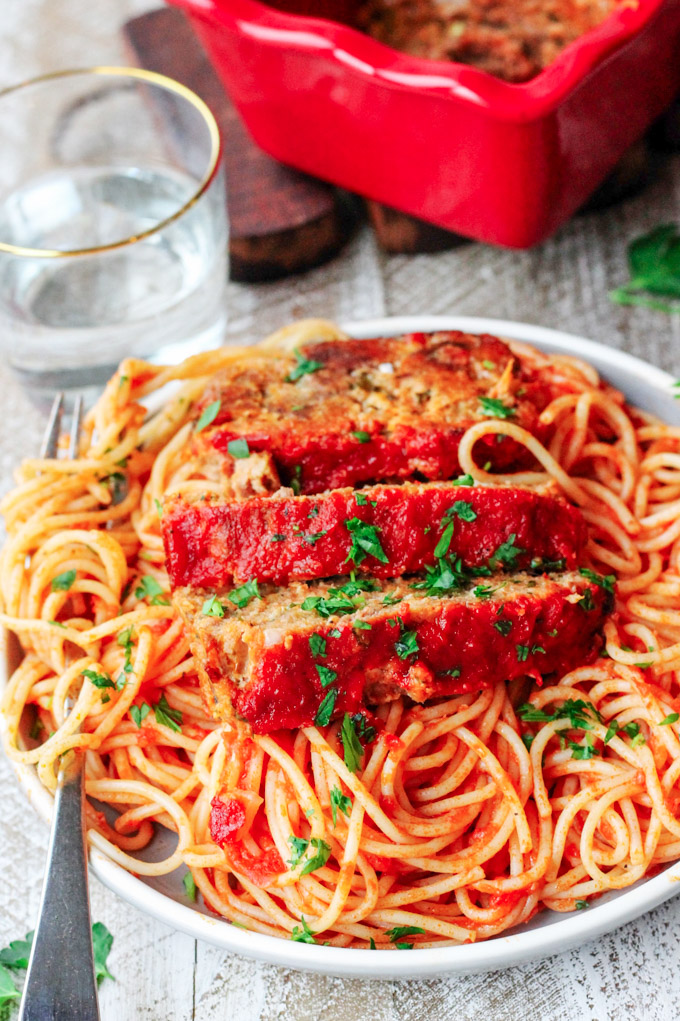 This Italian-Style Meatloaf recipe is a simple weeknight meal that is essentially a giant meatball, but easier to make. This delicious twist on a family favorite has all of the Italian flavors you love mixed in with beef, pork, and veal!