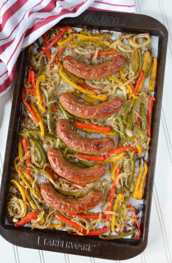 Looking for a quick, easy, and affordable family meal they'll love? Make this simple Sausage + Pepper Sheet Pan Meal in 30 minutes. It’s a ten-dollar dinner that can be served over rice or on hoagie rolls!