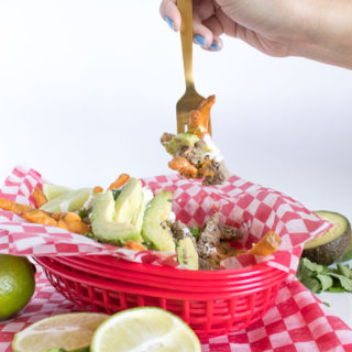 Celebrate cheat day with an over-the-top helping of Loaded Cheesy Taco Fries! Seasoned french fries are topped with taco seasoned beef, cheese sauce, sour cream, avocado, and more! Perfect for happy hour entertaining at home.