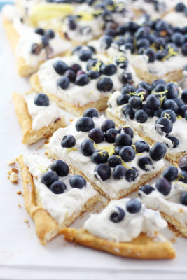 This irresistible Blueberry Cheesecake Dessert Pizza is a semi-homemade dessert recipe that uses only six ingredients and is ready in 30 minutes. Mounds of fresh blueberries are nested in a pillow of no-bake cheesecake fluff over a crescent roll crust.