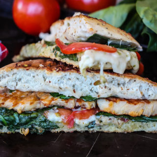 You're only six simple ingredients and 15 minutes away from a drool-worthy, deli-style meal. This Pesto Chicken Panini is a healthier classic you can make at home with chicken, pesto, spinach, Swiss, and tomatoes.
