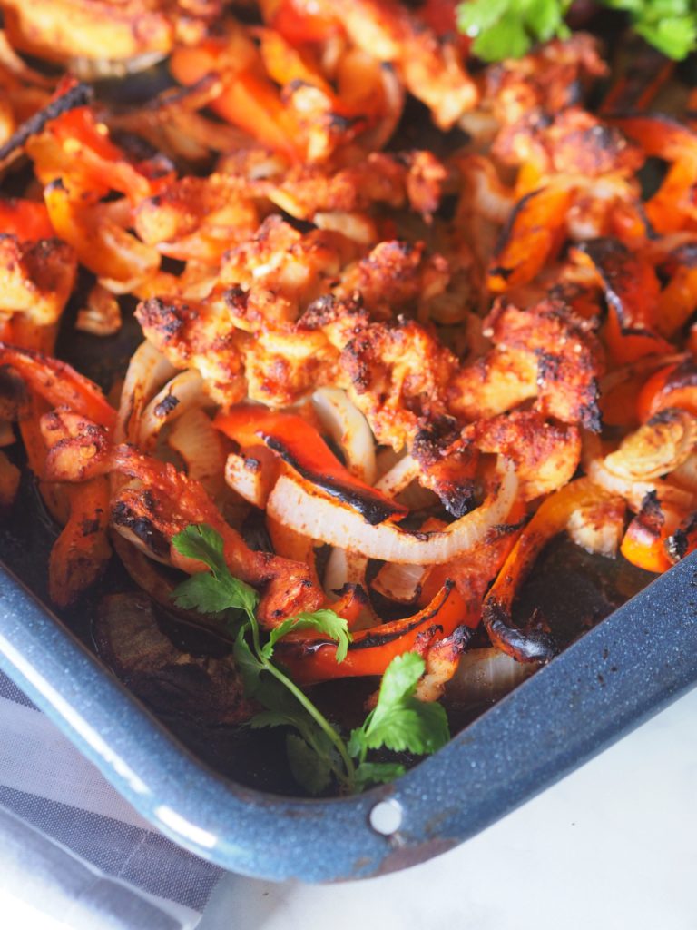 This simple Sheet Pan Chicken Fajitas recipe is a 30-minute meal perfect for your weeknight dinner. This sheet pan meal is made with chicken, bell pepper, onions, and a combination of fragrant spices.