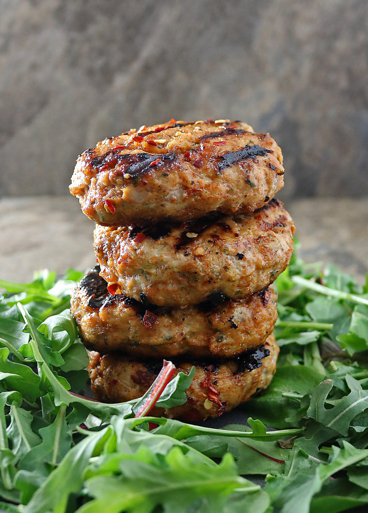 Outdoor grilling season is here and it's time to make these easy Grilled Honey Chili Chicken Burgers. Perfect for meal prep for the week, these sweet and spicy burgers are perfect for entertaining or a weeknight meal. Serve on buns or in a salad!
