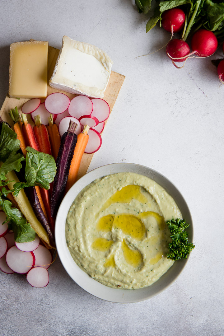 This White Bean Dip + Veggie Picnic Platter comes together in just 10 minutes. It's the perfect appetizer for outdoor entertaining. Made with white cannellini beans, this party dip pairs perfectly with seasonal vegetables like carrots and radishes.