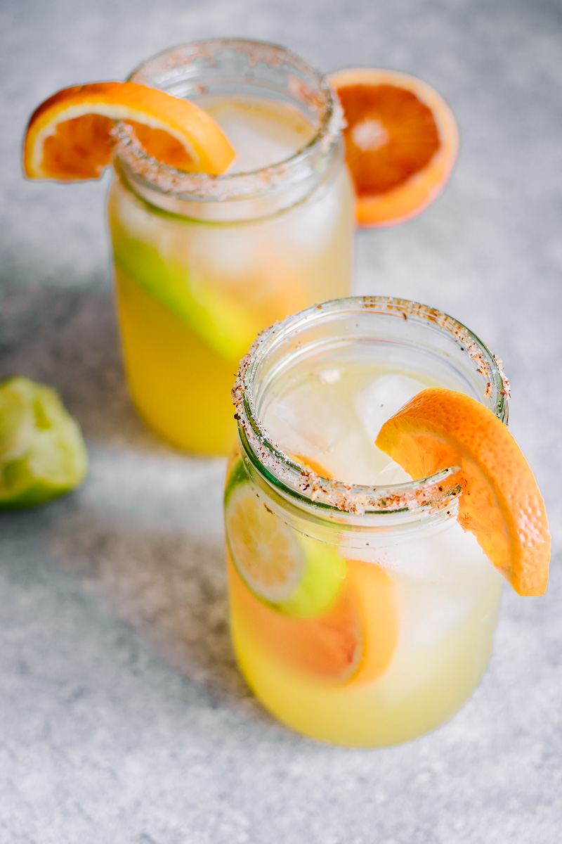 Orange, lemon, lime, and a dash of chili powder give these Spicy Citrus Margaritas a unique flavor that's sure to be a hit at happy hour. The spicy chili lime salted rim gives this fun twist on a classic cocktail the signature look it deserves!