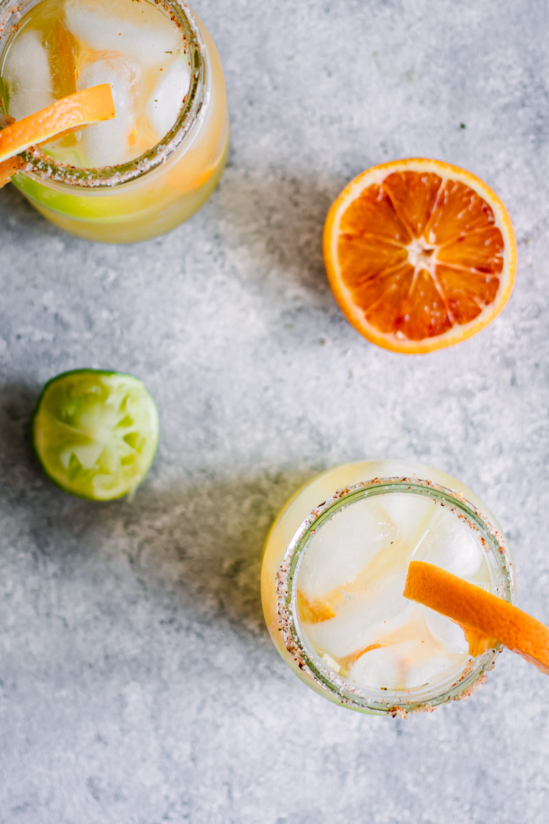 Orange, lemon, lime, and a dash of chili powder give these Spicy Citrus Margaritas a unique flavor that's sure to be a hit at happy hour. The spicy chili lime salted rim gives this fun twist on a classic cocktail the signature look it deserves!