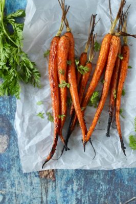 Caramelized Roasted Carrots are the perfect light side dish to serve with chicken or fish. Just four simple ingredients turn these farmers market fresh carrots into an amazing side dish that's perfect for a weeknight dinner or for entertaining guests.