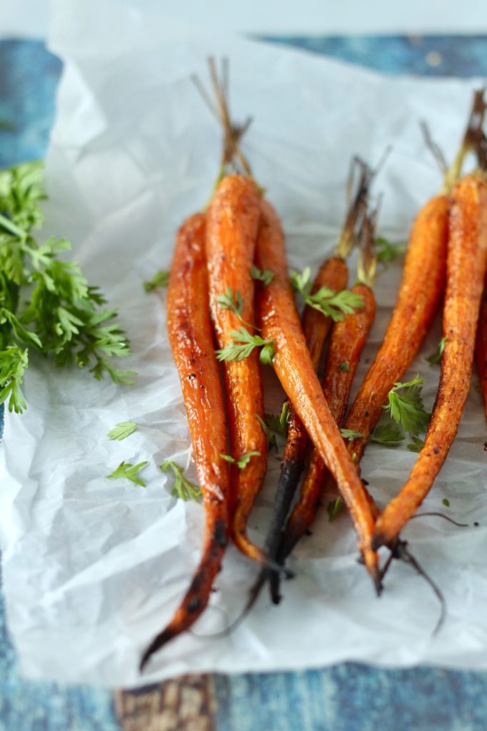 Caramelized Roasted Carrots are the perfect light side dish to serve with chicken or fish. Just four simple ingredients turn these farmers market fresh carrots into an amazing side dish that's perfect for a weeknight dinner or for entertaining guests.