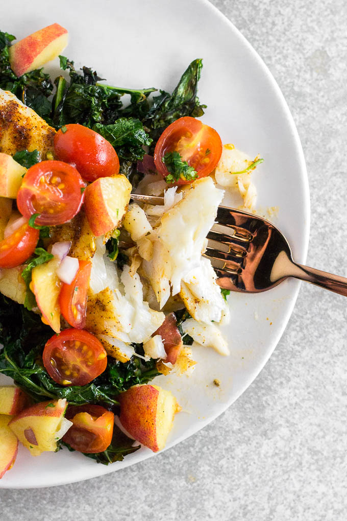 This Baked Cod with Peach Tomato Salsa is a farmers market delight! A 20-minute meal made entirely from fresh farmers market finds that's perfect for your weeknight dinner. This cheap healthy meal is bursting with flavor and color!