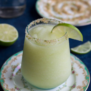 This Frozen Honey Dew Margarita is a tequila-based summer cocktail with a generous dose of fruit and sweet and salty rim. The perfect drink to sip on after a long day, happy hour, or outdoor entertaining with friends.