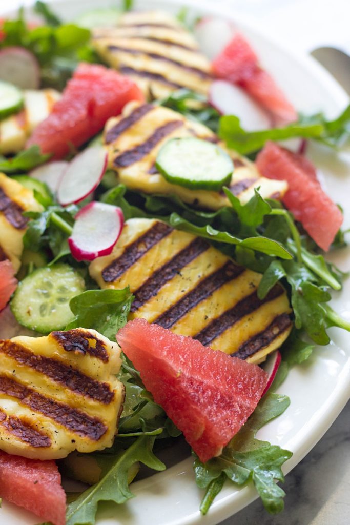 This Grilled Halloumi Salad with watermelon and arugula is a delightful spring/summer salad ready in 15 minutes. Easy enough for a weeknight meal, but impressive enough for outdoor entertaining.