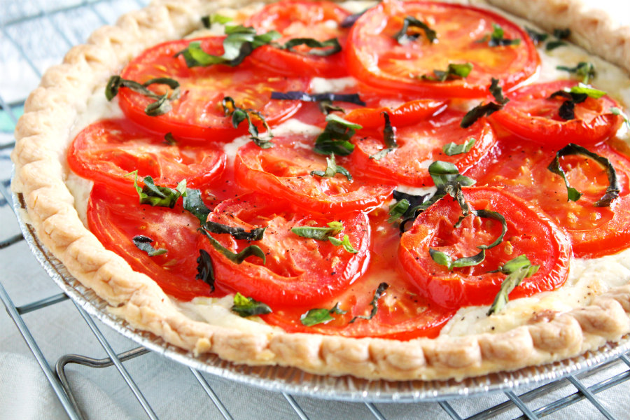 This beautiful Jersey Tomato 3-Cheese Tart is filled with a trio of cheeses and topped with fresh tomato slices and basil. It's the perfect vegetarian dish or party appetizer to make with fresh tomatoes from the farmers market or garden!