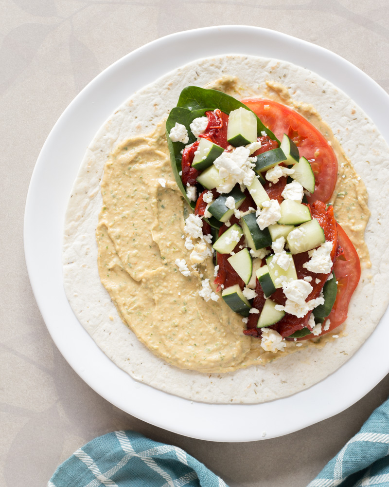 Why waste money at your favorite sandwich shop when you can make this Mediterranean-inspired Cilantro Jalapeño Hummus Wrap at home. This cheap healthy meal is a 10-minute lunch or dinner with fresh veggies and hummus.