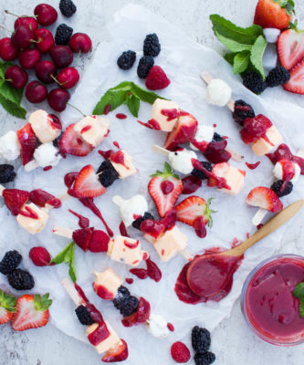 These Ice Cream Fruit Kebabs with Berry Sauce are the perfect easy dessert recipe for summer entertaining. All of the season's favorite flavors on a stick - ice cream, farmers market fruit, and a sweet berry sauce you'll love!