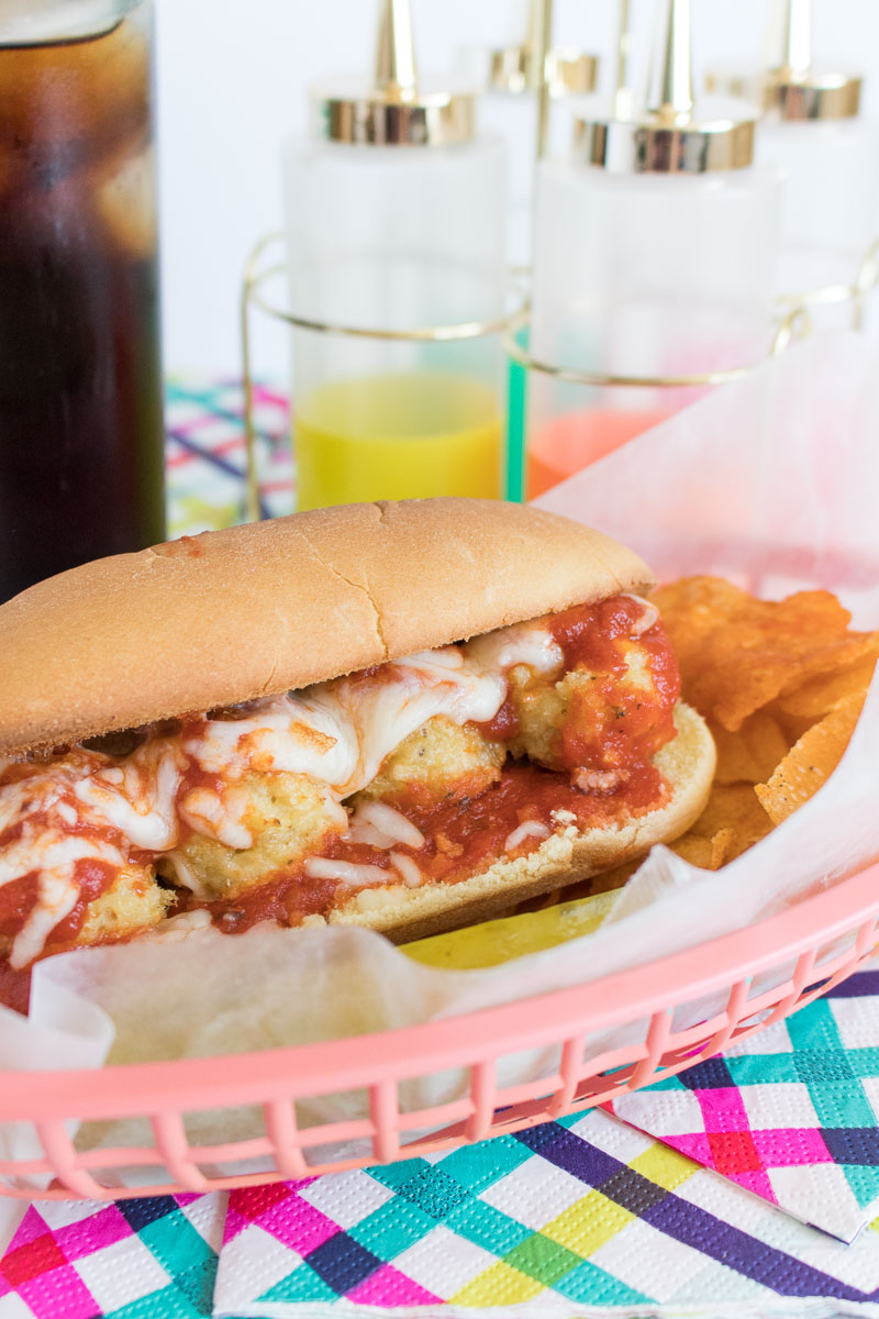 This slightly lightened-up Chicken Parmesan Meatball Sub sandwich is filled with homemade baked meatballs, marinara sauce, and melted cheese! A budget-friendly, deli-style meal you'll love that's ready in 30 minutes.