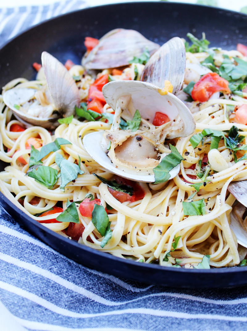 This Garlicky Clams Linguine recipe is a simple 30-minute meal you can make at home. This restaurant-style meal is made of linguine pasta with clams coated in a buttery garlic sauce, tomatoes, and garden-fresh basil.
