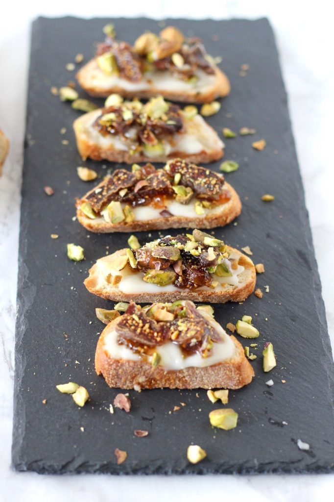 You're sure to impress party guests when you set out a platter of these Baked Brie Crostini with Figs and Pistachios. These savory small bites will be loved by all. A 5-ingredient appetizer perfect for happy hour!