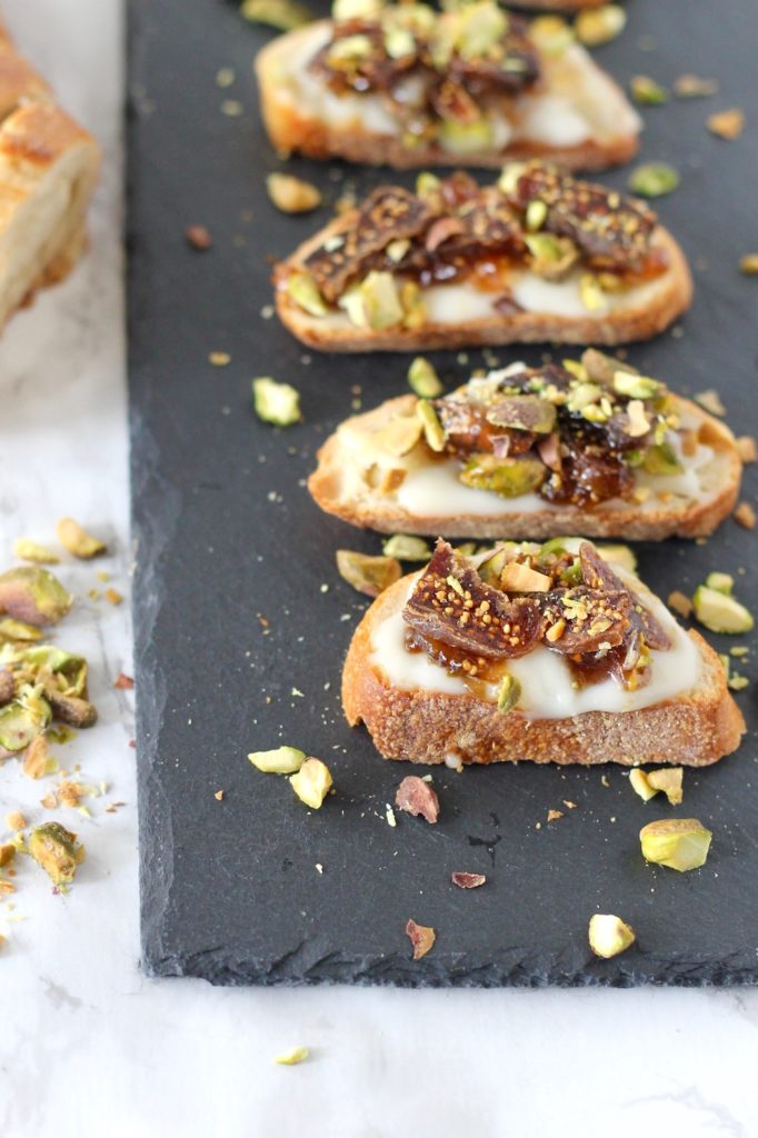You're sure to impress party guests when you set out a platter of these Baked Brie Crostini with Figs and Pistachios. These savory small bites will be loved by all. A 5-ingredient appetizer perfect for happy hour!