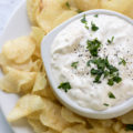This Caramelized Onion Dip is an easy appetizer served with chips or veggies that's perfect for happy hour entertaining. The caramelized onions are made with a white wine reduction which makes this classic party dip the perfect white wine pairing!