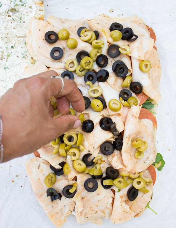 adding olives to the sandwich