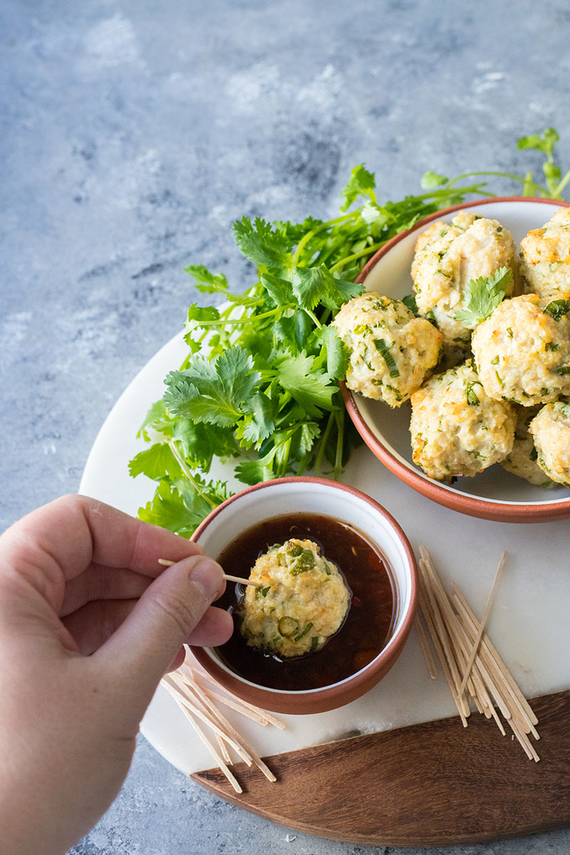 These Vietnamese-Style Chicken Meatballs are great for outdoor entertaining. Baked chicken meatballs made with fresh lemongrass and the flavors of Asia, when paired with a spicy dipping sauce, are the perfect party appetizer.