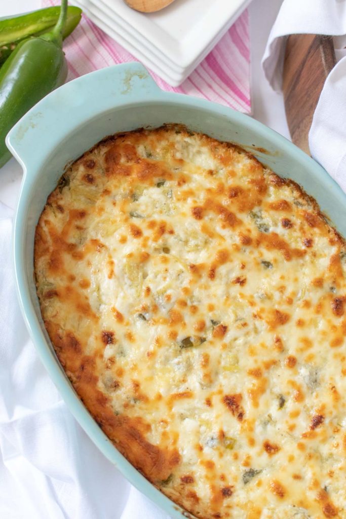 Whether you're outdoor entertaining, hosting happy hour at home, or celebrating a big event, this simple Cheesy Jalapeño Artichoke Dip is the appetizer you need on the party table!