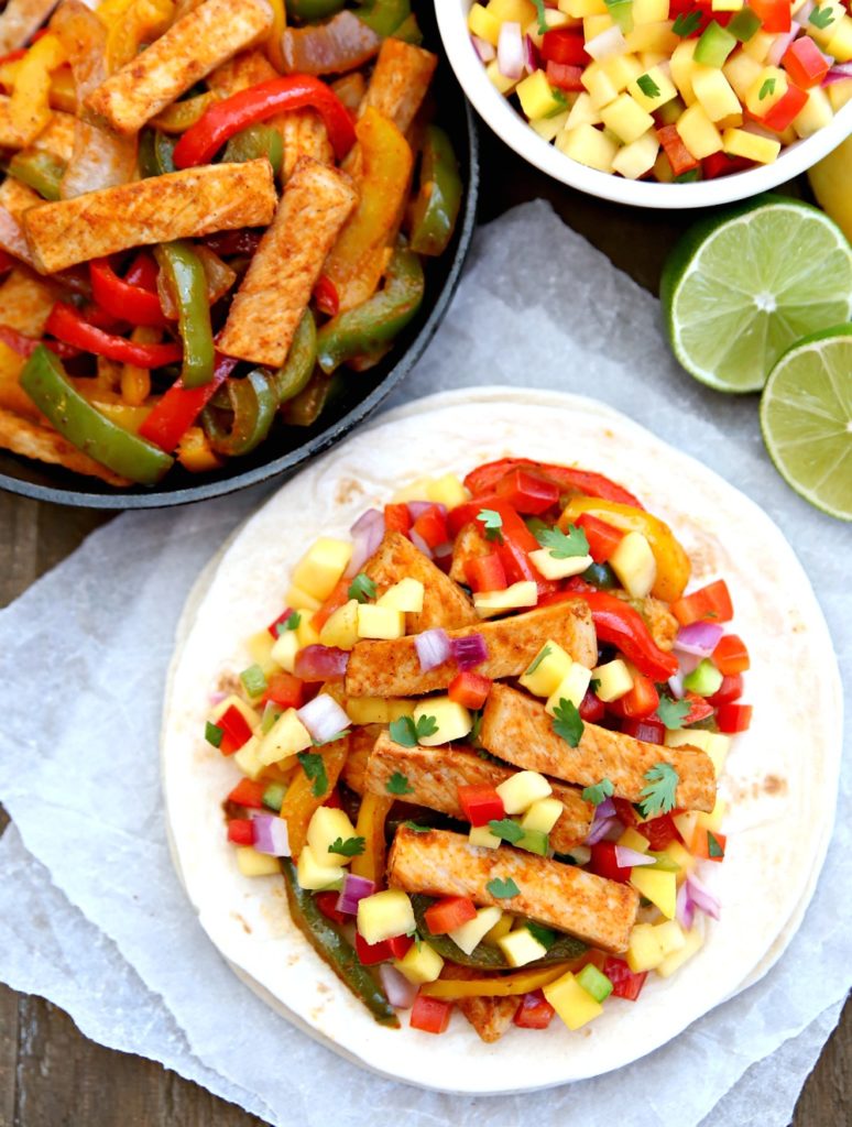 These Grilled Pork Fajitas are the perfect 30-minute meal for a busy weeknight dinner. This easy dinner recipe gets a sweet makeover with farmers market fresh Mango Salsa that's the perfect touch for summer entertaining.