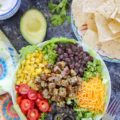 Loaded with grilled veggie burgers, black beans, and all of your favorite taco fixings, this Protein-Packed Vegetarian Taco Salad is the perfect easy weeknight dinner. This cheap healthy meal is a great one to serve during the summer entertaining months!