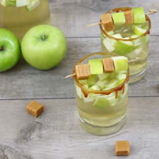 This Caramel Apple White Sangria recipe is a light and crisp cocktail filled with fall flavors. Perfect for happy hour entertaining, tailgating, or a girls' night in, this seasonal cocktail is ideal for transitioning from summer to fall.