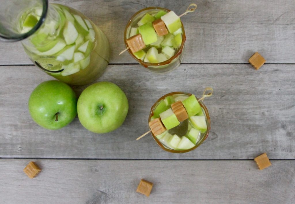 This Caramel Apple White Sangria recipe is a light and crisp cocktail filled with fall flavors. Perfect for happy hour entertaining, tailgating, or a girls' night in, this seasonal cocktail is ideal for transitioning from summer to fall.