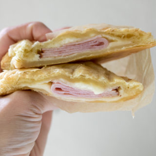 These 3-ingredient Cheesy Ham Puff Pastry Pockets are perfect for easy school lunches or after-school snacks. These tasty hand pies are delicious hot or cold, your kids will love them, and they only take 20 minutes to make!