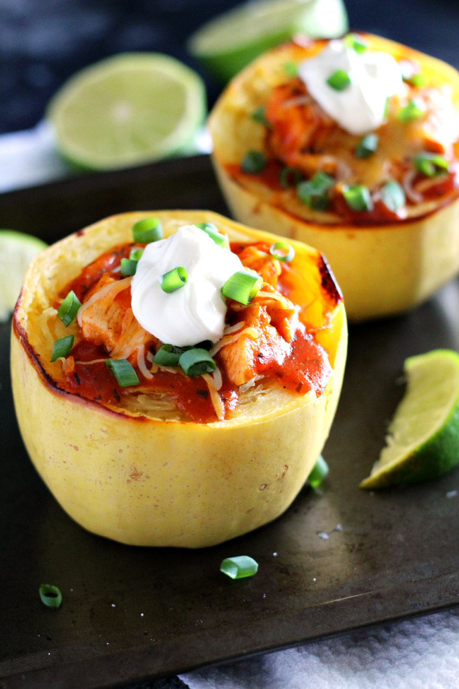 Looking for a low-carb meal that's completely satisfying? This Chicken Enchilada Spaghetti Squash is the answer! Cook the squash ahead during your weekly meal prep then make this cheap healthy meal for a busy weeknight dinner.