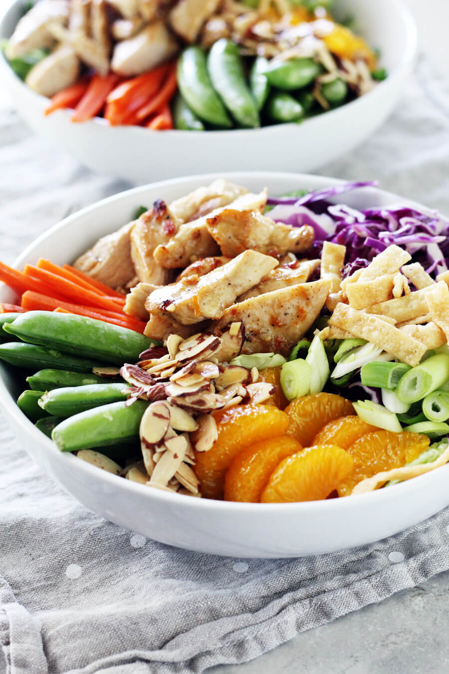 Whether you're entertaining guests or having a date night dinner in, this Chinese Chicken Mandarin Salad Bowl is perfect. Full of savory Chinese flavors, this cheap healthy meal is a quick weeknight dinner solution and delicious to boot!