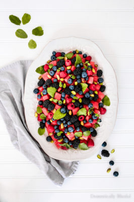 Whether you're outdoor entertaining, planning the perfect picnic, or want a healthy dessert for your weeknight dinner, this Farmers Market Mixed Berry Mint Watermelon Salad needs to be on the menu. A beautiful fruit platter topped with pistachios in just 15 minutes!