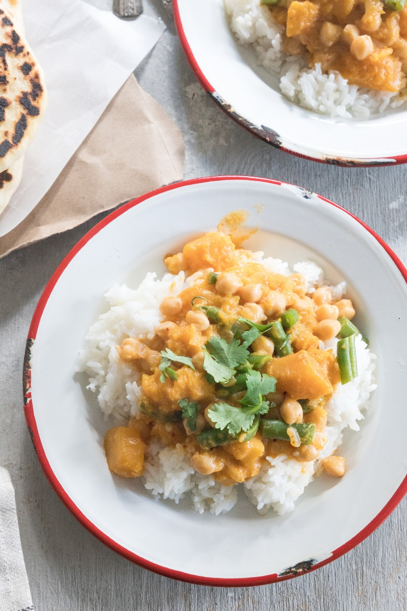 Perfect for those looking for more plant-based meals in their diet, this Pumpkin Chickpea Curry is a cheap healthy meal you'll love! This easy-to-make vegetarian dish is pure comfort food on a plate.