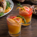 Sweet, tart, and bubbly, this Cranberry Apple Cider Fizz is the perfect mocktail for your holiday menu. This festive drink embodies the fall flavors of apple, cranberry, orange, and rosemary. Booze it up for a fall cocktail you'll love!
