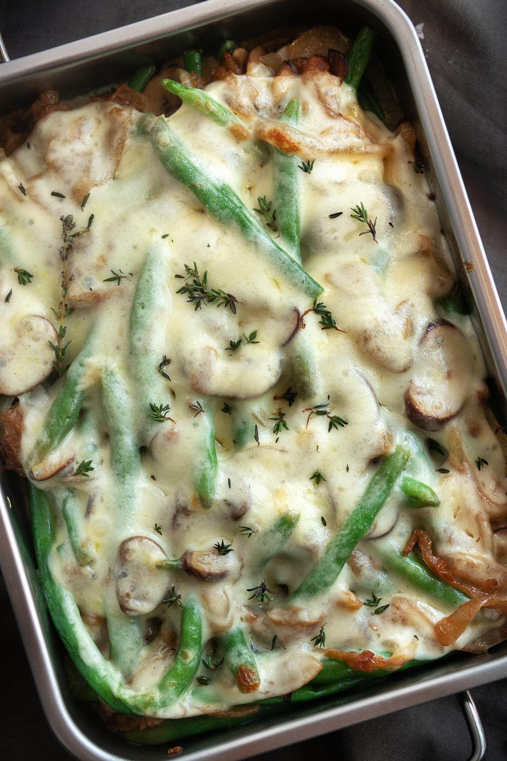These Cheesy French Onion Green Beans are a flavorful twist on the classic green bean casserole. Whether you're entertaining for Friendsgiving, attending a family gathering, or bringing something to your office potluck, this is the portable side dish you need to bring!