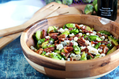 Warm Brussels Sprouts Salad is the perfect portable side dish for an office potluck or family feast. Seasonal produce is served with bacon, blue cheese, and pecans. A unique side dish to liven up the holiday dinner menu.
