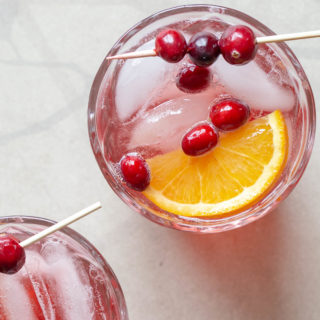 This 4-ingredient Cranberry Prosecco Aperol Spritzer is a festive twist on a classic cocktail. With the addition of cranberry simple syrup and orange slices, the bold, seasonal flavors of this wine-based cocktail are perfect for holiday entertaining or happy hour!