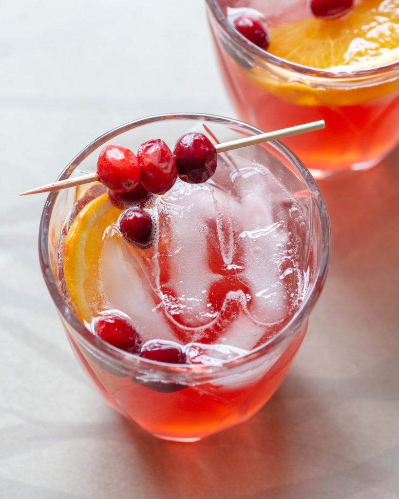This 4-ingredient Cranberry Prosecco Aperol Spritzer is a festive twist on a classic cocktail. With the addition of cranberry simple syrup and orange slices, the bold, seasonal flavors of this wine-based cocktail are perfect for holiday entertaining or happy hour!
