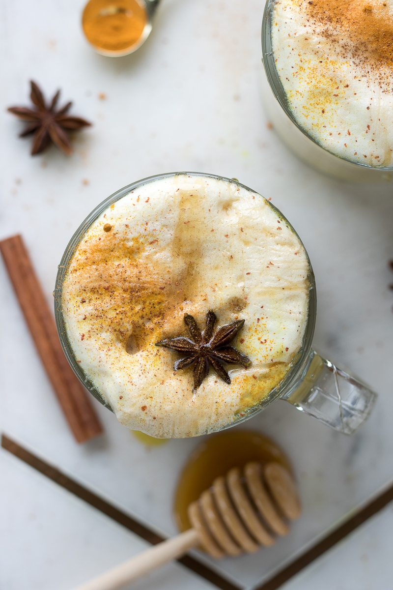 This Turmeric Golden Milk Latte is a hot, spiced drink with 1-2 shots of espresso in each cup. This refined sugar-free drink uses wildflower honey or maple syrup to get it's sweetness and is flavored with black pepper, cinnamon, star anise, cardamom and ginger. This drink recipe (with a vegan latte option) is perfect to warm you up on a cold day!
