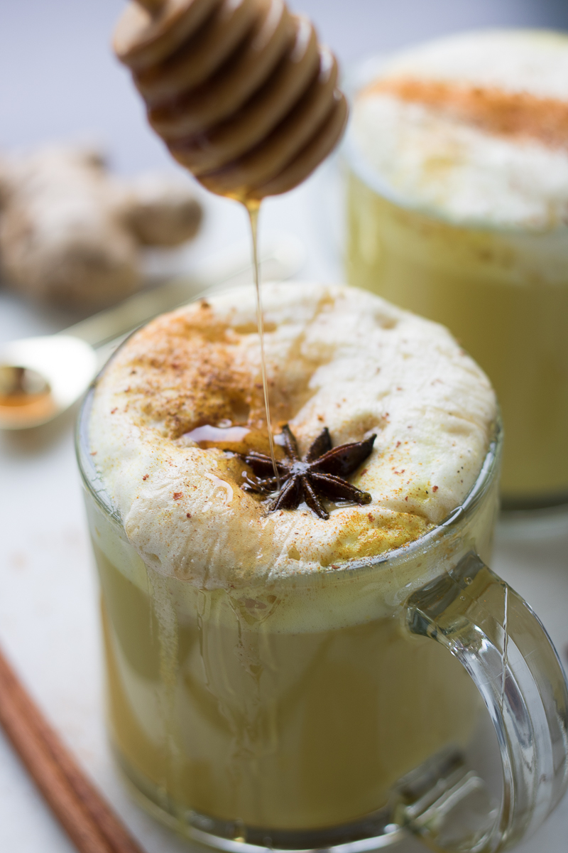 This Turmeric Golden Milk Latte is a hot, spiced drink with 1-2 shots of espresso in each cup. This refined sugar-free drink uses wildflower honey or maple syrup to get it's sweetness and is flavored with black pepper, cinnamon, star anise, cardamom and ginger. This drink recipe (with a vegan latte option) is perfect to warm you up on a cold day!